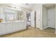 Bathroom featuring a double sink vanity, tile flooring and large mirror at 1520 Ethans Way, Mcdonough, GA 30252