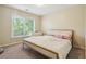 Comfortable bedroom with a light-colored bed frame and a large window at 1520 Ethans Way, Mcdonough, GA 30252