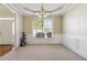 Bright dining room featuring wainscoting, tray ceiling, and a chandelier at 1520 Ethans Way, Mcdonough, GA 30252