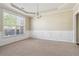 Elegant dining room featuring a tray ceiling, wainscoting, and a large window at 1520 Ethans Way, Mcdonough, GA 30252