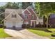 Charming two-story home with a brick facade, two-car garage, and manicured lawn at 1520 Ethans Way, Mcdonough, GA 30252