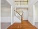 Bright foyer featuring hardwood floors, a staircase, and views of the second-floor landing at 1520 Ethans Way, Mcdonough, GA 30252