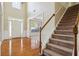 Grand foyer with hardwood floors, staircase, and a view into the living room at 1520 Ethans Way, Mcdonough, GA 30252