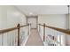 Hallway featuring decorative wood trim railing offering a view to the lower level at 1520 Ethans Way, Mcdonough, GA 30252