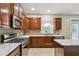 The updated kitchen boasts stainless steel appliances, tile backsplash, and plentiful cabinet space at 1520 Ethans Way, Mcdonough, GA 30252