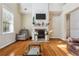 Bright living room features a fireplace, wood floors, large window and neutral color palette at 1520 Ethans Way, Mcdonough, GA 30252