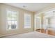 Inviting living room featuring large windows and neutral carpeting at 1520 Ethans Way, Mcdonough, GA 30252