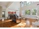 Spacious living room featuring hardwood floors, tall ceilings, and large windows at 1520 Ethans Way, Mcdonough, GA 30252