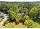 Aerial view of a secluded home surrounded by dense trees and lush greenery at 204 Holly Creek Way, Woodstock, GA 30188