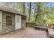 Outdoor wooden deck with bench and railings, offering a serene space surrounded by lush trees at 204 Holly Creek Way, Woodstock, GA 30188