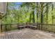 Spacious outdoor deck with seating overlooking a lush, wooded backyard at 204 Holly Creek Way, Woodstock, GA 30188