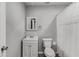 Bathroom features a toilet, vanity with sink and a shower with curtain at 204 Holly Creek Way, Woodstock, GA 30188