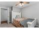 Comfortable bedroom featuring a ceiling fan and access to an adjoining room through a paneled door at 204 Holly Creek Way, Woodstock, GA 30188