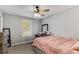 Cozy bedroom with a ceiling fan, a window providing natural light, and warm carpeting at 204 Holly Creek Way, Woodstock, GA 30188