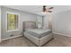 Neutral bedroom featuring a ceiling fan, carpeted floors, and natural light streaming through two windows at 204 Holly Creek Way, Woodstock, GA 30188