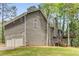 Exterior view of home with a two-car garage and rear deck at 204 Holly Creek Way, Woodstock, GA 30188