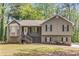 Charming home with a welcoming front porch, stone accents, and beautiful landscaping at 204 Holly Creek Way, Woodstock, GA 30188
