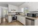Well-lit kitchen with stainless steel appliances and granite countertops at 204 Holly Creek Way, Woodstock, GA 30188