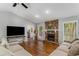 Cozy living room featuring a stone fireplace and lots of natural light at 204 Holly Creek Way, Woodstock, GA 30188