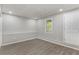 Bright and airy room with neutral walls and modern vinyl plank flooring and recessed lighting at 204 Holly Creek Way, Woodstock, GA 30188
