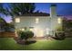 Exterior rear view of home at twilight featuring a patio, manicured lawn, and landscaped yard at 2264 Howell Farms Nw Trl, Acworth, GA 30101