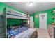 Bright bedroom featuring a bunk bed with playful dinosaur-themed bedding at 2264 Howell Farms Nw Trl, Acworth, GA 30101