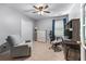 Bedroom with ceiling fan, neutral walls, and closet, furnished with desk, chair, and drawers at 2264 Howell Farms Nw Trl, Acworth, GA 30101