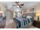 Comfortable bedroom with tray ceiling, a ceiling fan, and artwork on the walls at 2264 Howell Farms Nw Trl, Acworth, GA 30101