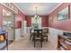 Formal dining room featuring neutral carpet, warm red walls, and large windows, perfect for Gathering gatherings at 2264 Howell Farms Nw Trl, Acworth, GA 30101