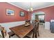 Inviting dining room featuring a dark wood table with seating for six, complemented by warm red walls at 2264 Howell Farms Nw Trl, Acworth, GA 30101