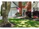 Beautifully landscaped front yard with lush lawn, colorful flowers, and shrubbery surrounding the home's entrance at 2264 Howell Farms Nw Trl, Acworth, GA 30101