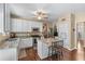 Charming kitchen featuring stainless-steel appliances, white cabinetry, a central island and hardwood flooring at 2264 Howell Farms Nw Trl, Acworth, GA 30101