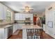 Modern kitchen featuring granite countertops, stainless steel appliances, white cabinets and central island with breakfast bar at 2264 Howell Farms Nw Trl, Acworth, GA 30101