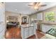 Bright kitchen featuring granite countertops, white cabinetry and stainless-steel appliances open to the living area at 2264 Howell Farms Nw Trl, Acworth, GA 30101