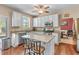 Updated kitchen with stainless steel appliances, granite counters, island seating, and access to the backyard patio at 2264 Howell Farms Nw Trl, Acworth, GA 30101