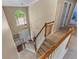 View of the staircase featuring carpeted steps, wood railings, and an arched window providing natural light at 2264 Howell Farms Nw Trl, Acworth, GA 30101