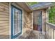 Balcony view featuring a blue trimmed door, light beige siding, wood flooring and view into an interior room at 2308 Country Park Se Dr, Smyrna, GA 30080