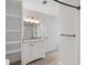 Clean bathroom with a white vanity, granite countertop, and built-in shelving for organized storage at 2308 Country Park Se Dr, Smyrna, GA 30080