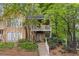 Inviting two-story townhouse with a landscaped front yard and cozy balcony, perfect for enjoying the surrounding greenery at 2308 Country Park Se Dr, Smyrna, GA 30080