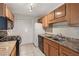 Functional kitchen with granite countertops, wood cabinets, and black appliances for easy meal preparation at 2308 Country Park Se Dr, Smyrna, GA 30080