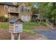 Condominium exterior with community mailboxes surrounded by mature trees and shrubs at 2308 Country Park Se Dr, Smyrna, GA 30080