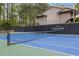 A tennis court with the Country Park Private Community logo on the fencing behind the net at 2308 Country Park Se Dr, Smyrna, GA 30080