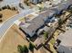 Aerial shot of a home highlighting its backyard with a patio area, surrounded by a fenced yard and mature trees at 441 Spring View Dr, Woodstock, GA 30188