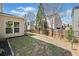 Fenced backyard showing grass, landscaping, and a view of neighboring homes at 441 Spring View Dr, Woodstock, GA 30188