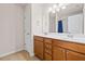 Bathroom features a double vanity, a large mirror with lights, and a shower with a blue curtain at 441 Spring View Dr, Woodstock, GA 30188