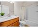 Cozy bathroom featuring wood vanity, sleek sink, and shower with elegant curtain at 441 Spring View Dr, Woodstock, GA 30188