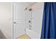 Bathroom features a white door, a bathtub and shower combo, and a blue curtain for added privacy at 441 Spring View Dr, Woodstock, GA 30188