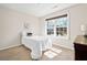 Bright bedroom with a twin bed is illuminated by a large window and features neutral walls and carpet at 441 Spring View Dr, Woodstock, GA 30188