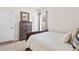 Neutral bedroom with a wood dresser and a cozy bed at 441 Spring View Dr, Woodstock, GA 30188