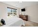 Bright bedroom features a TV, a chest of drawers, a large window, and a cozy atmosphere for relaxation at 441 Spring View Dr, Woodstock, GA 30188